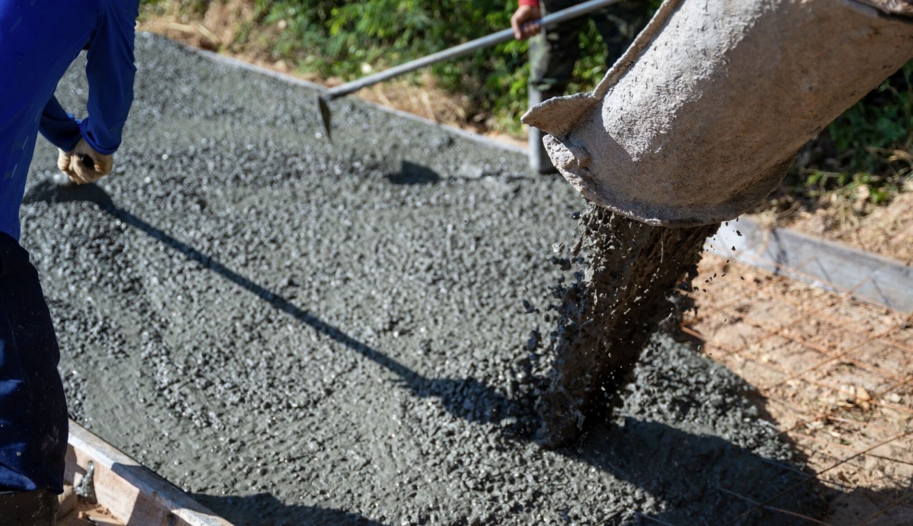 Skilled concrete worker pouring fresh concrete in Diamond Bar